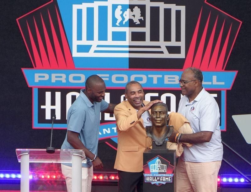 Roderick Craig joins his father Roger Craig of the San Francisco 49ers and his childhood friend and Jamie Williams, 49ers teammate, after unveiling Craig’s bust at the  2026 Pro Football Hall of Fame Enshrinement in Canton on August 8, 2026.