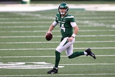 Sam Darnold (14) of the New York Jets looks to pass against the Miami Dolphins during their NFL game at MetLife Stadium on November 29, 2020 in East Rutherford, New Jersey.