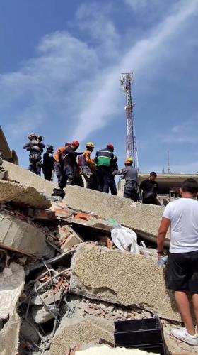 Rescue efforts to find survivors from rubble of a collapsed residential building along coastline of Caraballeda