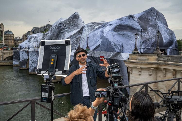 French artist JR gives an interview on the day of the public opening of his monumental work Caverne du Pont-Neuf on the Pont-Neuf, in Paris, France on June 15, 2026.