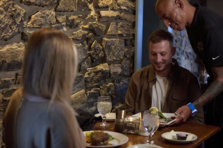 Visitors dine inside the Tavern.