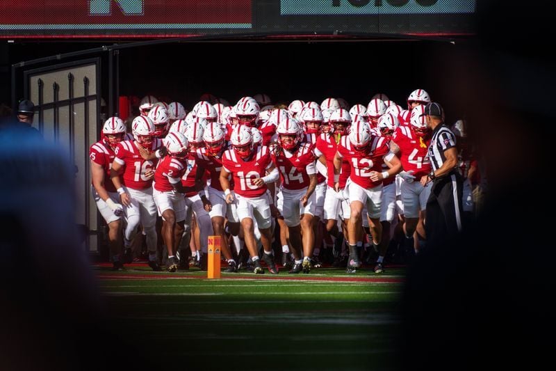 Sep 12, 2026; Lincoln, Nebraska, USA;  The Nebraska Cornhuskers run onto the field before the game against the Bowling Green Falcons at Memorial Stadium.  Mandatory Credit: Dylan Widger-Imagn Images