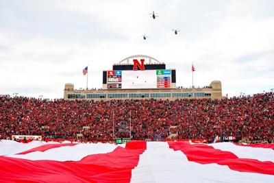 Nov 11, 2023; Lincoln, Nebraska, USA; Three CH-47 Chinook helicopters fly over the field during the national anthem before the game between the Nebraska Cornhuskers and the Maryland Terrapins at Memorial Stadium. Mandatory Credit: Dylan Widger-USA TODAY...