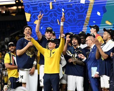 Michigan head coach Dusty May points to the crowd after the Wolverines defeated UConn, 69-63, in the NCAA Tournament championship at Lucas Oil Stadium on April 6, 2026, in Indianapolis.