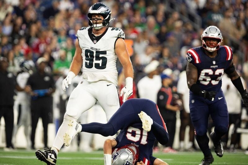 Aug 22, 2026; Foxborough, Massachusetts, USA;  Philadelphia Eagles defensive tackle Ty Robinson (95) tackles New England Patriots quarterback Tommy DeVito (16) in the first quarter at Gillette Stadium.  Mandatory Credit: Edward Finan-Imagn Images