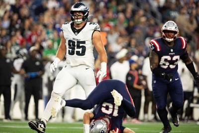 Aug 22, 2026; Foxborough, Massachusetts, USA;  Philadelphia Eagles defensive tackle Ty Robinson (95) tackles New England Patriots quarterback Tommy DeVito (16) in the first quarter at Gillette Stadium.  Mandatory Credit: Edward Finan-Imagn Images