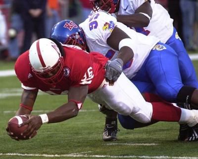Nebraska's Correll Buckhalter (36) stretches to put the ball over the goal line to score in the third quarter, despite the defense of Kansas' Ervin Holloman, November 4, 2000. Nebraska defeated Kansas 56-17.

TK/HB