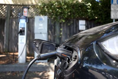 A Nissan electric car sits parked at a Charge Point EV charging station on July 28, 2023, in San Anselmo, California.