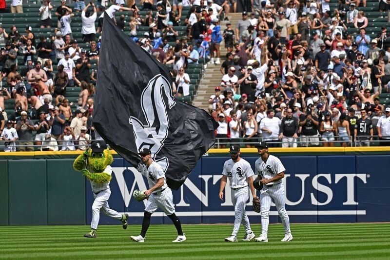 Jul 11, 2026; Chicago, Illinois, USA; Chicago White Sox left fielder Randal Grichuk (34), center fielder Tristan Peters (29) and right fielder Braden Montgomery (24) celebrate, as mascot Southpaw waves the flag, after defeating the Athletics at Rate Fie...