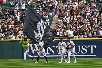 Jul 11, 2026; Chicago, Illinois, USA; Chicago White Sox left fielder Randal Grichuk (34), center fielder Tristan Peters (29) and right fielder Braden Montgomery (24) celebrate, as mascot Southpaw waves the flag, after defeating the Athletics at Rate Fie...