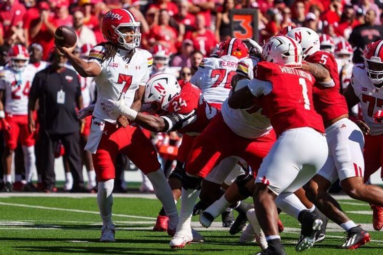 Oct 3, 2026; Lincoln, Nebraska, USA;  Maryland Terrapins quarterback Malik Washington (7) throws the ball away as he is hit by Nebraska Cornhuskers linebacker Dexter Foster (24) during the first quarter at Memorial Stadium.  Mandatory Credit: Dylan Widg...