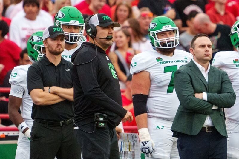 Sep 19, 2026; Lincoln, Nebraska, USA;  North Dakota Fighting Hawks head coach Eric Schmidt watches from the sideline during the first quarter against the Nebraska Cornhuskers at Memorial Stadium.  Mandatory Credit: Dylan Widger-Imagn Images