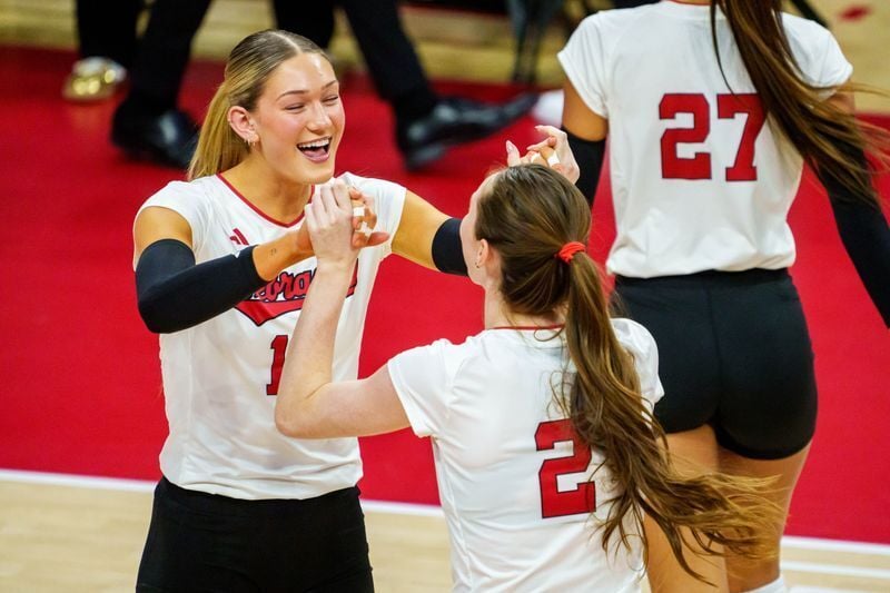 Dec 12, 2025; Lincoln, NE, USA; Nebraska Cornhuskers middle blocker Andi Jackson (15) and setter Bergen Reilly (2) greet on the court before the match against the Kansas Jayhawks at Bob Devaney Sports Center. Mandatory Credit: Dylan Widger-Imagn Images