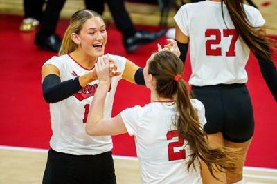 Dec 12, 2025; Lincoln, NE, USA; Nebraska Cornhuskers middle blocker Andi Jackson (15) and setter Bergen Reilly (2) greet on the court before the match against the Kansas Jayhawks at Bob Devaney Sports Center. Mandatory Credit: Dylan Widger-Imagn Images