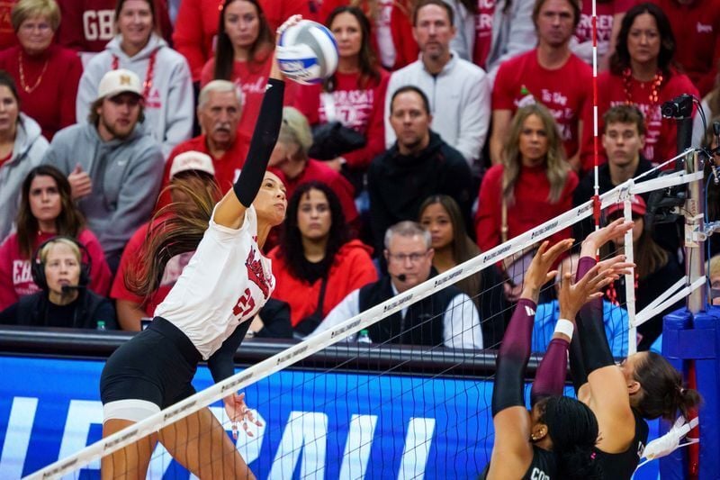 Dec 14, 2025; Lincoln, NE, USA; Nebraska Cornhuskers outside hitter Harper Murray (27) attacks against Texas A&M Aggies middle blocker Ifenna Cos-Okpalla (1) and opposite hitter Logan Lednicky (9) during the first set at Bob Devaney Sports Center. Manda...