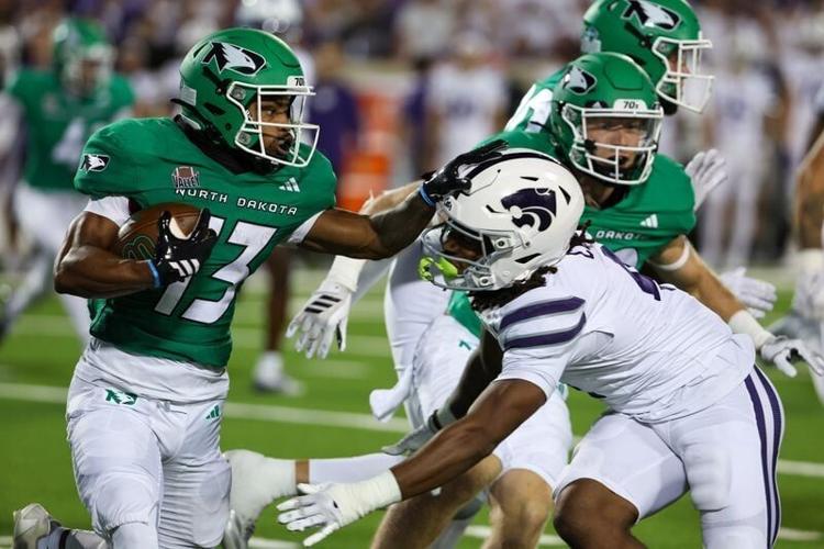 Aug 30, 2025; Manhattan, Kansas, USA; North Dakota Fighting Hawks wide receiver Kristen Hoskins (13) is tackled by Kansas State Wildcats safety Daniel Cobbs (4) during the fourth quarter at Bill Snyder Family Football Stadium. Mandatory Credit: Scott Se...