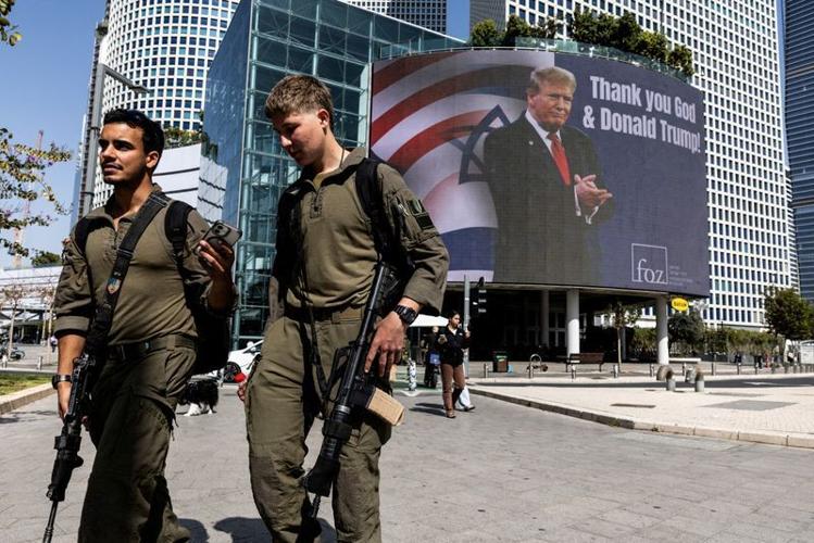 FILE PHOTO: People walk by a billboard commissioned by an evangelical group, amid the U.S.-Israel conflict with Iran, in Tel Aviv