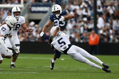 Apr 26, 2025; University Park, PA, USA; Penn State Nittany Lions running back Tikey Hayes (23) leaps over cornerback Daryus Dixson (5) during the third quarter of the Blue White spring game at Beaver Stadium. The White team defeated the Blue team 10-8. ...
