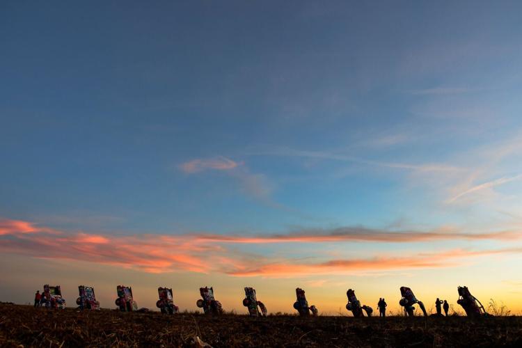 Visitors to Cadillac Ranch art installation in Amarillo, Texas, are allowed to spray the 10 Cadillacs half-buried in the ground there, seen on Nov. 11, 2025.