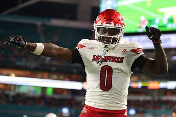 Oct 17, 2025; Miami Gardens, Florida, USA; Louisville Cardinals wide receiver Chris Bell (0) celebrates after scoring a touchdown against the Miami Hurricanes during the first quarter at Hard Rock Stadium.
