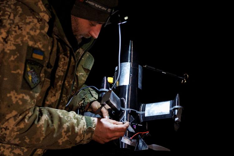 FILE PHOTO: Ukrainian serviceman prepares an FPV interceptor drone for a launch during his combat shift in Kharkiv region