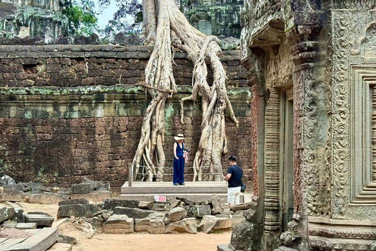 Taking a picture at Ta Prohm temple, without the usual crowds.
