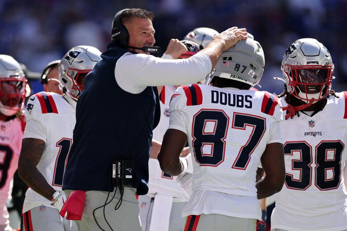 Head coach Mike Vrabel of the New England Patriots congratulates Romeo Doubs after a touchdown against the Buffalo Bills during the first quarter at Highmark Stadium on Sunday, Oct. 4, 2026, in Orchard Park, N.Y..