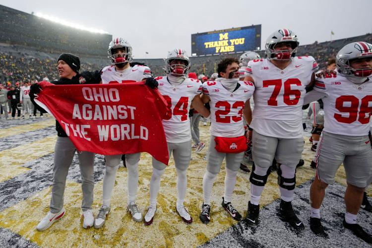 Ohio State players celebrate after their win against Michigan on the field at Michigan Stadium in Ann Arbor, Mich. on Nov. 29, 2025.