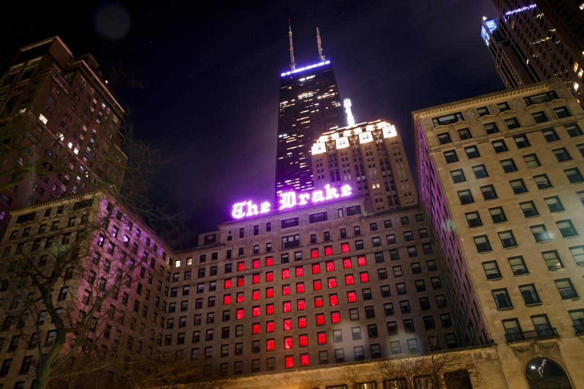 Red windows form a heart inside the Drake Hotel in support of the hospitality for hope initiative Monday April 20, 2020, in Chicago.