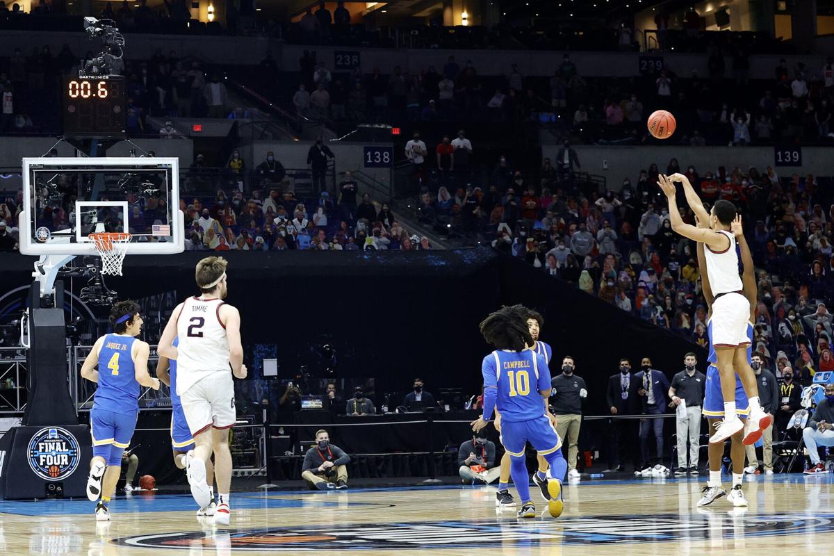 Jalen Suggs of the Gonzaga Bulldogs shoots a game-winning three-point basket in overtime to defeat the UCLA Bruins 93-90 during the 2021 NCAA Final Four semifinal at Lucas Oil Stadium on April 03, 2021 in Indianapolis, Indiana.