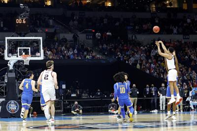 Jalen Suggs of the Gonzaga Bulldogs shoots a game-winning three-point basket in overtime to defeat the UCLA Bruins 93-90 during the 2021 NCAA Final Four semifinal at Lucas Oil Stadium on April 03, 2021 in Indianapolis, Indiana.