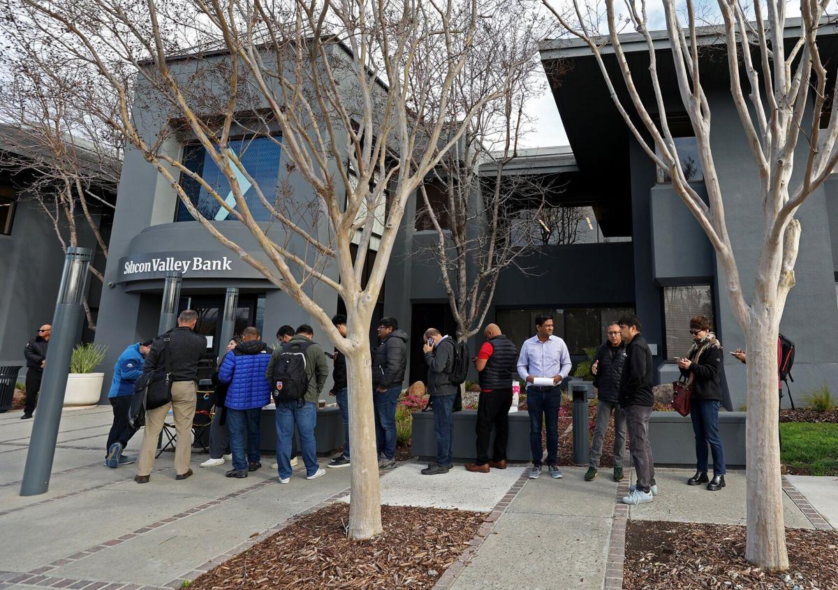 People line up outside a Silicon Valley Bank office Monday in Santa Clara, California.