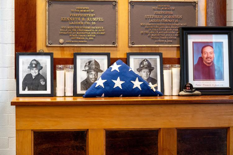 A mantle hold photos firefighters who lost their lives from the Sept. 11, 2001 attack during an annual event where retired