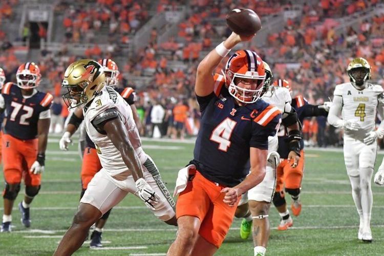 Sep 3, 2026; Champaign, Illinois, USA;  Illinois Fighting Illini quarterback Katin Houser (4) scores a touchdown during the second half against the UAB Blazers at Gies Memorial Stadium.  Mandatory Credit: Ron Johnson-Imagn Images
