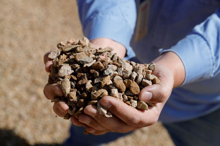 FILE PHOTO: Matt Green, mining/crushing supervisor at MP Materials, displays crushed ore before it is sent to the mill at the MP Materials rare earth mine in Mountain Pass