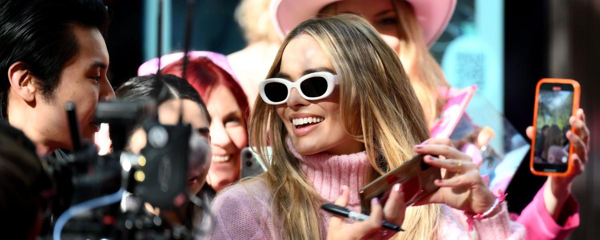 "Barbie" star Margot Robbie poses for photos with fans during a fan event at Westfield Sydney in Australia in June. (Photo by James Gourley/Getty Images)