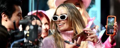 "Barbie" star Margot Robbie poses for photos with fans during a fan event at Westfield Sydney in Australia in June. (Photo by James Gourley/Getty Images)