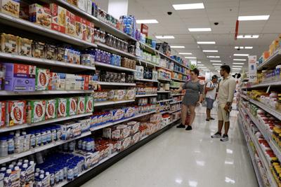 Customers shop at a Target store in Miami. Target announced plans to cut prices on thousands of basics as inflation cuts into household budgets. (Photo by Joe Raedle/Getty Images)