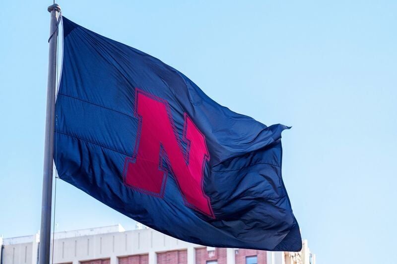 Nov 1, 2025; Lincoln, Nebraska, USA; A black Nebraska Cornhuskers flag waves outside the stadium before the game against the Southern California Trojans at Memorial Stadium. Mandatory Credit: Dylan Widger-Imagn Images
