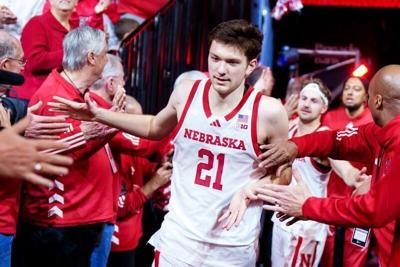 Feb 14, 2026; Lincoln, Nebraska, USA; Nebraska Cornhuskers forward Pryce Sandfort (21) runs onto the court while being greeted by alumni players before the game against the Northwestern Wildcats at Pinnacle Bank Arena. Mandatory Credit: Dylan Widger-Ima...