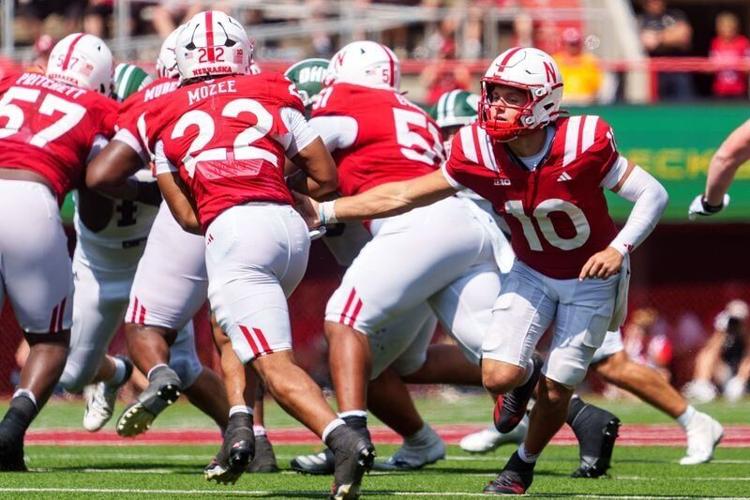 Sep 5, 2026; Lincoln, Nebraska, USA;  Nebraska Cornhuskers quarterback Anthony Colandrea (10) hands off to running back Isaiah Mozee (22) during the fourth quarter against the Ohio Bobcats at Memorial Stadium.  Mandatory Credit: Dylan Widger-Imagn Images