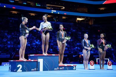 Second- and first-place winners Claire Pease (left) and Hezly Rivera (middle) greet each other on the podium after competing in the Xfinity U.S. Gymnastics senior women's championships at the Mortgage Matchup Center on Aug. 9, 2026, in Phoenix.