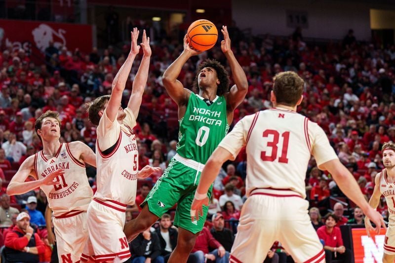 Dec 21, 2025; Lincoln, Nebraska, USA; North Dakota Fighting Hawks forward Marley Curtis (0) shoots the ball against Nebraska Cornhuskers forward Braden Frager (5), forward Pryce Sandfort (21) and guard Cale Jacobsen (31) during the second half at Pinnac...