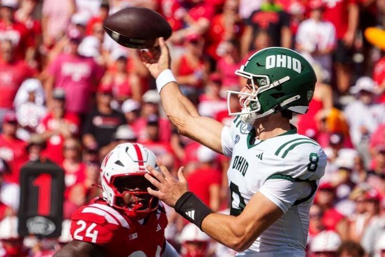 Sep 5, 2026; Lincoln, Nebraska, USA;  Ohio Bobcats quarterback Nick Poulos (8) passes against Nebraska Cornhuskers linebacker Dexter Foster (24) during the first quarter at Memorial Stadium.  Mandatory Credit: Dylan Widger-Imagn Images