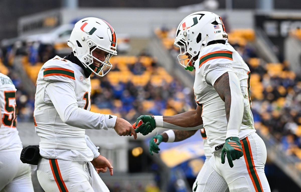 Miami running back Charmar Brown celebrates with quarterback Carson Beck after a 9- yard touchdown reception in the third quarter against Pittsburgh at Acrisure Stadium on Saturday, Nov. 29, 2025, in Pittsburgh.