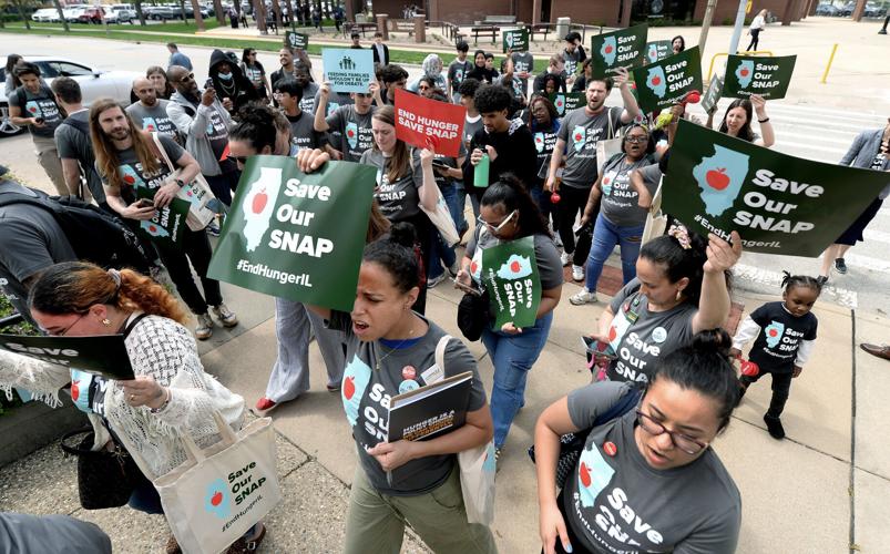 Rally goers march from the Capitol Complex Visitors Center to the Illinois State Capitol during the Supplemental Nutrition Assistance Program rally on April 14, 2026, in Springfield, Illinois.