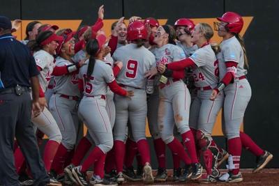 Nebraska's Hannah Camenzind (9) celebrates with teammates after hitting a home run during a NCAA super regional game between Tennessee and Nebraska at Sherri Parker Lee Stadium in Knoxville, Tenn., on May 23, 2025.