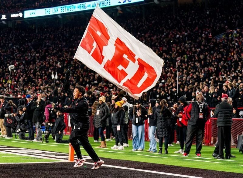 Nov 1, 2025; Lincoln, Nebraska, USA; A Nebraska Cornhuskers cheerleader carries a flag across the field after a score against the Southern California Trojans during the fourth quarter at Memorial Stadium. Mandatory Credit: Dylan Widger-Imagn Images