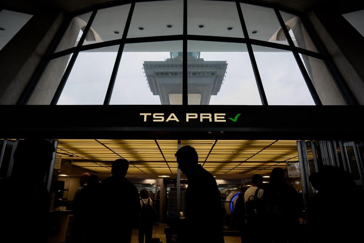 Travelers move through security at Washington Dulles International Airport on May 22, 2026, in Dulles, Virginia.