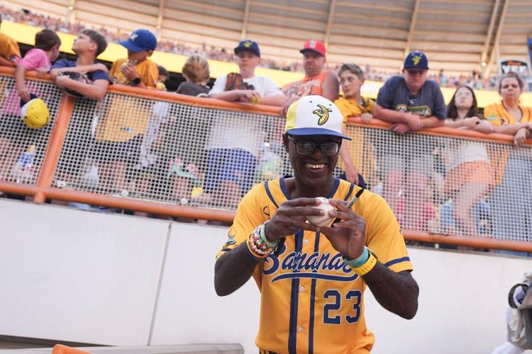 Savannah Bananas Inspirational Coach Reginald Horton signs autographs for Banana Ball fans at the Savannah Bananas and Texas
